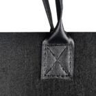 Close-up of a black leather handle attached to a fabric, featuring detailed stitching in an X pattern on the square leather patch at the base. The handle is positioned vertically against a plain white background.