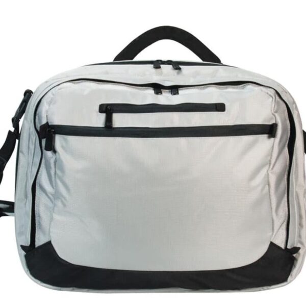 A gray travel backpack featuring a large front pocket with a horizontal zipper, two black side pockets, a top handle, and an adjustable shoulder strap. The bag has black accents on the bottom corners and zippers.