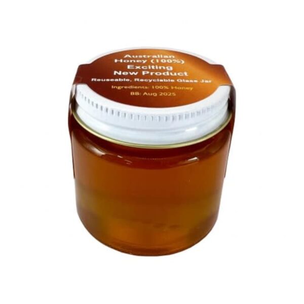 The Honey Jar is a glass jar with a white lid, labeled Australian Honey (100%), Exciting New Product, Reusable, Recyclable Glass Jar, with ingredients as 100% Honey and a best-before date of August 2025.