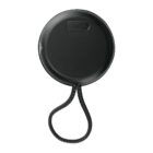 Round black electronic device with a cord attached and an IN label on top.