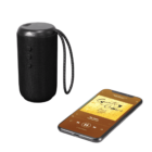 A black portable speaker beside a smartphone playing music.
