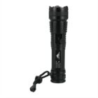 A black flashlight with a textured grip and a wrist strap attached at the base, standing upright on a white background.