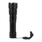 A black tactical flashlight with a textured grip and a wrist strap attached at the end. The flashlight has a sturdy, cylindrical design and is shown standing upright against a white background.
