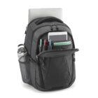 A black backpack with multiple compartments, holding a laptop and a tablet. The front pocket is open, displaying pens and a notebook. A water bottle is in the side mesh pocket.