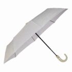 A gray, foldable umbrella with a textured pattern. It features a curved handle, primarily in white, and a black stem. The umbrella is partially open, showcasing its design and structure.