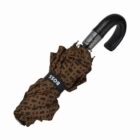 A folded brown umbrella with a pattern of black squares. It has a black, curved handle and a strap with the word BOSS on it.