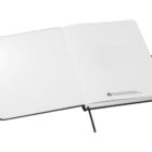 An open, blank notebook with white pages and a black ribbon bookmark rests on a surface. The notebook features a small recycling logo and text at the bottom of the right page.