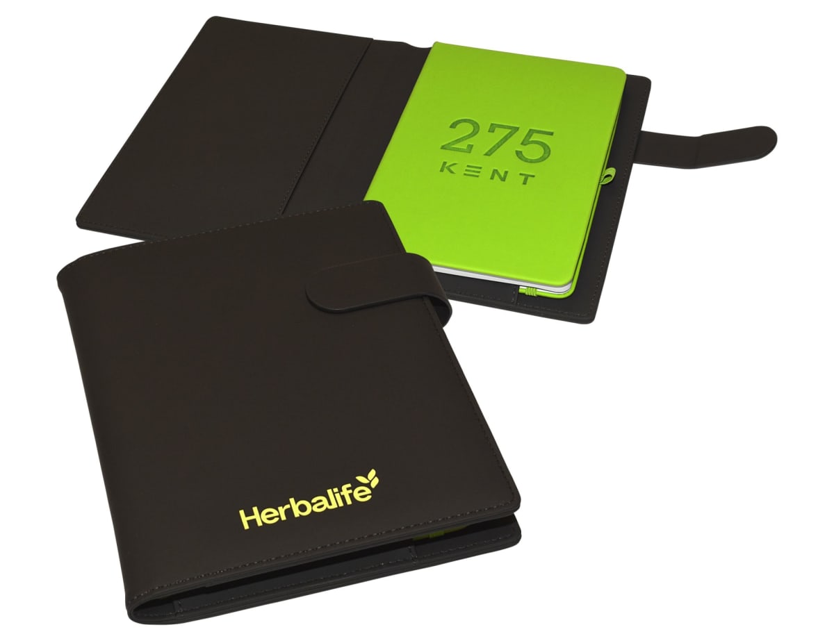 Two black leather folders featuring a green notebook inside. One folder is closed, displaying the Herbalife logo, while the other is open, revealing 275 KENT on the notebook cover. Both folders have a strap closure.