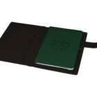 An open black book cover with a green notebook inside. The notebook has 275 KENT printed in bold black letters on the cover. The cover has a flap closure on the right side.