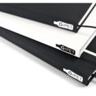 Close-up of three stacked notebooks with textured covers. The top is black, the middle is white, and the bottom is black. Each has an rPET tag, indicating they are made from recycled materials. Black elastic bands are visible on the outer edges.