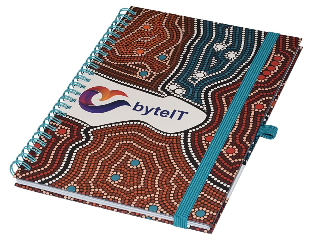 A spiral-bound notebook with a colorful dotted pattern in brown, white, and teal. The cover features the byteIT logo, and an elastic band secures it closed.