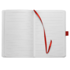 Open notebook with lined pages and a red ribbon bookmark lying loosely on the right page.