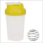 A transparent plastic shaker bottle with a yellow lid and a white flip cap. Next to the bottle is a metal shaker ball, used for mixing protein powders or supplements.