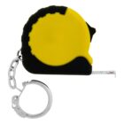 A small yellow and black measuring tape attached to a metal keychain. The tape has a retractable metal strip with markings visible. The design is compact, suitable for portable use.