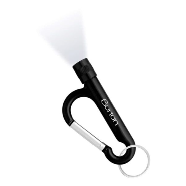 A black carabiner keychain with the word Burton engraved on it. Attached to the carabiner is a small, lit flashlight. A silver keyring is connected to the bottom of the carabiner.