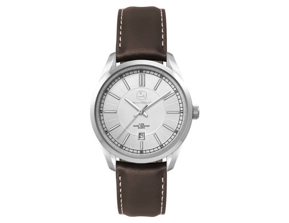 A wristwatch with a silver dial, black hour markers, and a date display at 6 oclock. It has a stainless steel case and a brown leather strap with white stitching.