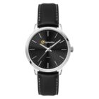 A sleek black wristwatch with a silver case and black leather strap. It features a minimalist design with silver hour markers and hands. The watch face has a logo with the word Symantec and a small Quartz label below.