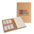 A notebook folder with Safe Space Mental Health & Wellness Clinic on the cover. Inside, there are six pastel-colored sticky notes labeled with days of the week, and a lined notepad. The folder cover is made of brown kraft paper.