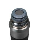 Close-up of a stainless steel thermos with a closed gray lid. The thermos has a shiny metal finish and a cylindrical shape. The focus is on the top portion, highlighting the lid design.
