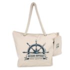 A beige tote bag with rope handles, featuring a nautical ship wheel design and the words Ocean Odyssey Yacht Charters in blue. A small matching pouch hangs from one handle.