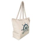 A beige canvas tote bag with thick rope handles and a nautical design. The bag features a ships wheel and the text Ocean Odyssey Yacht Charters in blue on its side.