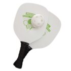Two pickleball paddles overlap, with a perforated white pickleball resting on them. The paddles have black grips and display green graphics and text that say PICKLEBALL CLASSIC TOURNAMENT.