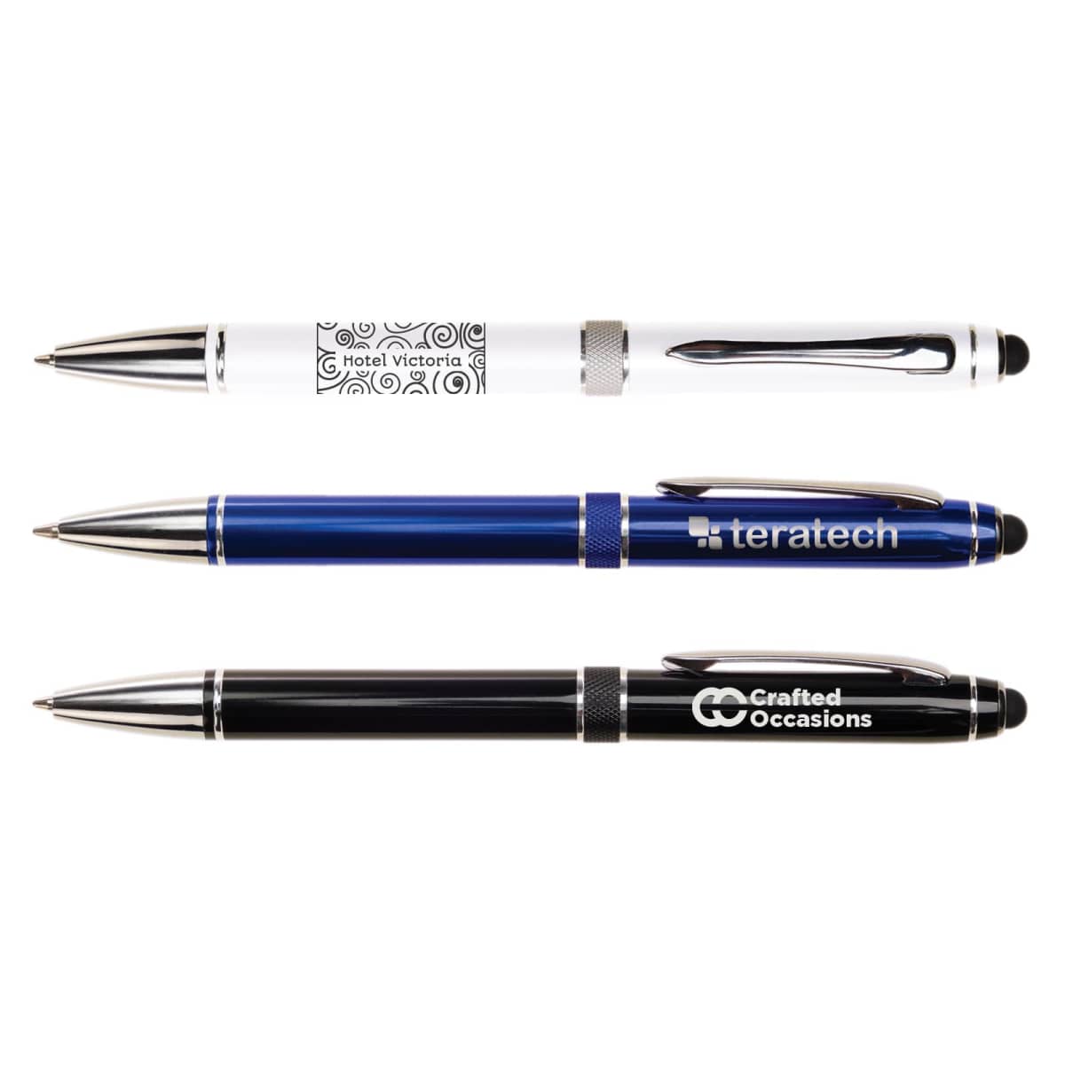 Three ballpoint pens with styluses: one white with decorative patterns, one blue labeled teratech, and one black labeled Crafted Occasions. All have silver accents and clips.
