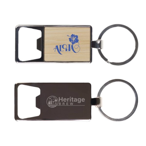 Two rectangular keychain bottle openers are shown. One features Aloha with a flower design on a bamboo inlay. The other has Heritage Brew with a tree and beer mug logo on a metallic body. Both have round keyrings attached.