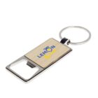 A rectangular keychain with a metal bottle opener. It has a wooden panel featuring a logo with lemons and the text Lemon & Lime in blue and yellow.