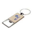 A rectangular keychain with a bottle opener function, featuring a wooden inlay and an Aloha text with a hibiscus design. The keyring is attached to the top, with a metal finish surrounding the wooden section.
