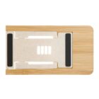 A top view of a rectangular bamboo cutting board featuring a detachable white plastic grater with black rubber grips. The grater is integrated into the board, allowing for easy use and storage.
