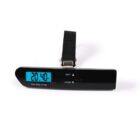 A black digital luggage scale with a blue backlit LCD screen displaying a weight of 20.40 kg. The scale features two buttons labeled UNIT and TARE, along with a strap for securing luggage.
