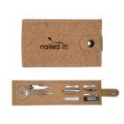 A cork-textured nail care kit with nailed it! printed on the cover. It opens to reveal nail scissors, clippers, tweezers, a cuticle pusher, and a nail file, all neatly organized in slots.
