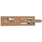 A brown leather manicure set case open, displaying various tools including scissors, nail clippers, cuticle pushers, tweezers, and a nail file, all neatly secured in place.