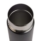 A close-up of an open metal thermos with a shiny, smooth stainless steel interior and a dark exterior. The thermos is shown from a top-down perspective against a plain white background.