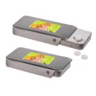 Two silver metal dispensers with colorful picnic-themed stickers. One is open, revealing small white pills or mints, while the other is closed. The dispensers have a sleek, rectangular design.