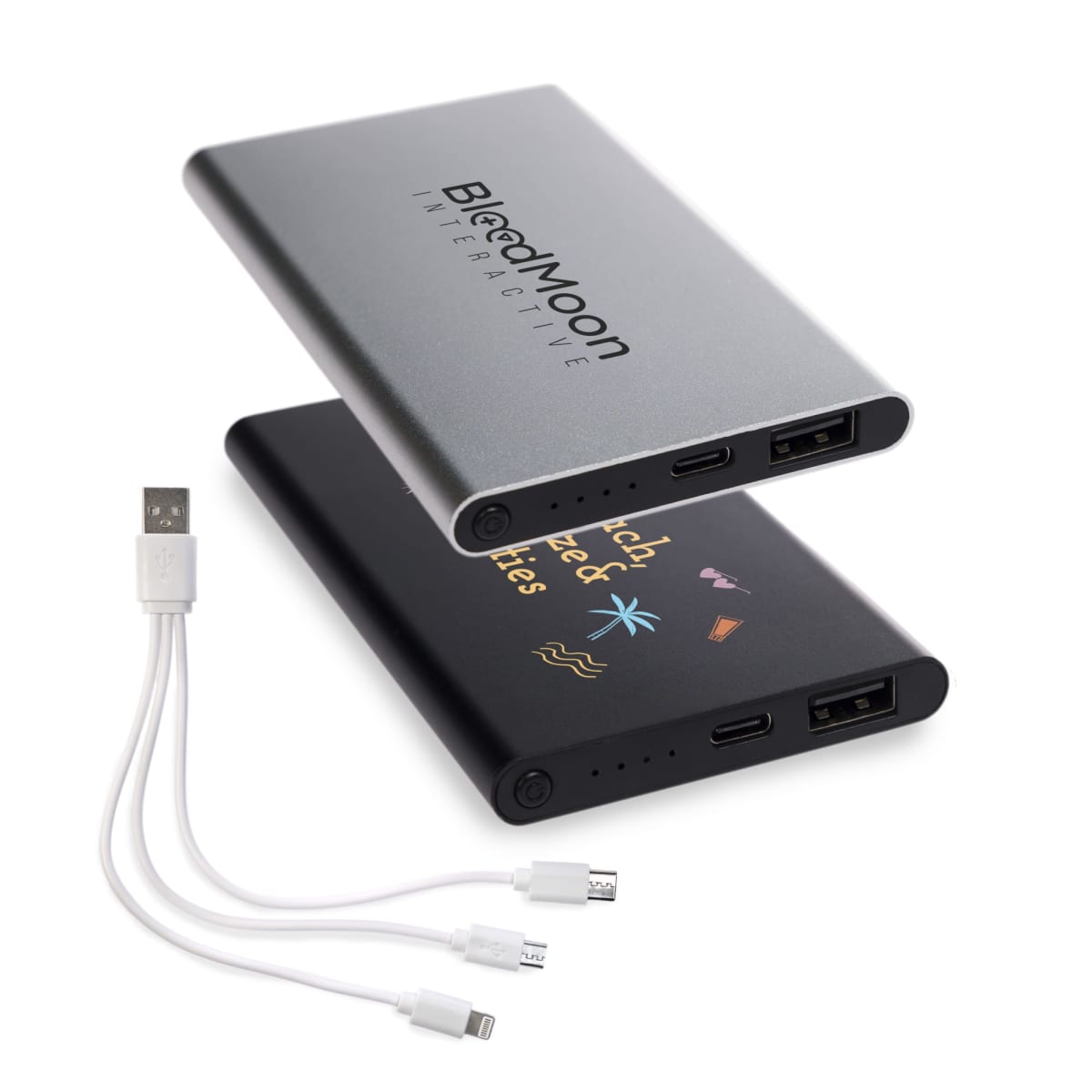 Two slim portable power banks, one silver with BlackMoon Interactive text and the other black with colorful graphics, are shown alongside a white multi-tip USB charging cable with micro USB, USB-C, and Lightning connectors.