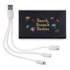 A black portable power bank with a playful design featuring palm trees and drinks. It reads Beach, Booze & Besties in colorful lettering. Attached are multiple charging cables, including USB, micro USB, and Lightning connectors.