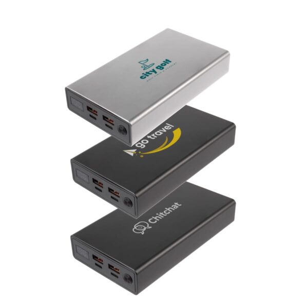 Three stacked power banks with different logos: a silver one with a City Golf logo, a black one with a Go Travel logo, and another black one with a Chitchat logo. Each has multiple USB ports on the side.