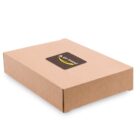 A closed, flat brown cardboard box with a black label featuring a yellow swoosh design and the text go travel on the lid. The box is placed on a plain white background.