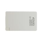 Rectangular white power bank with text and specifications printed on one side, including capacity and compatibility information. It features a port for charging.