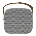 A portable speaker with a sleek, square design featuring a perforated front for sound output. It has a white frame and comes with a brown leather strap for easy carrying.