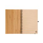 An open spiral-bound notebook with a wooden cover. The right page features lined paper with a recycling symbol in the bottom corner, while the left side shows the wood texture. The notebook lies flat on a white background.