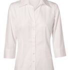 A white button-up blouse with three-quarter sleeves, featuring a classic collar and a simple, elegant design. The shirt is displayed against a plain background.