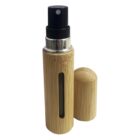 A bamboo-finished spray bottle with a removable cap, showing a small visible section of the inner container. The bottle has a sleek, natural design and is standing upright with the cap placed beside it.