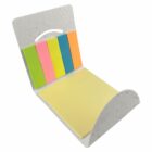 A white dispenser holds sticky notes in various colors: green, pink, yellow, blue, and orange. A larger yellow pad is at the bottom, with all pads laid in an open, fan-like arrangement.