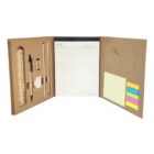 An open brown stationery folder displaying a lined notepad, sticky notes in various colors, a ruler, pen, and other office supplies neatly arranged in compartments.