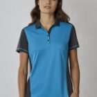 A person wearing a blue and dark gray polo shirt stands against a neutral background. They have long, dark hair and are looking directly at the camera.