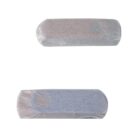 Two rectangular bars wrapped in translucent paper. The top one appears white, while the bottom one looks slightly blue-gray. The wrappers allow a glimpse of the bars’ texture beneath.