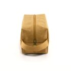 A brown fabric toiletry bag with a zipper closure on top, a handle on one end, and a rectangular shape. The bag is positioned upright, highlighting its sturdy design and simplicity. The fabric has a slightly textured appearance.